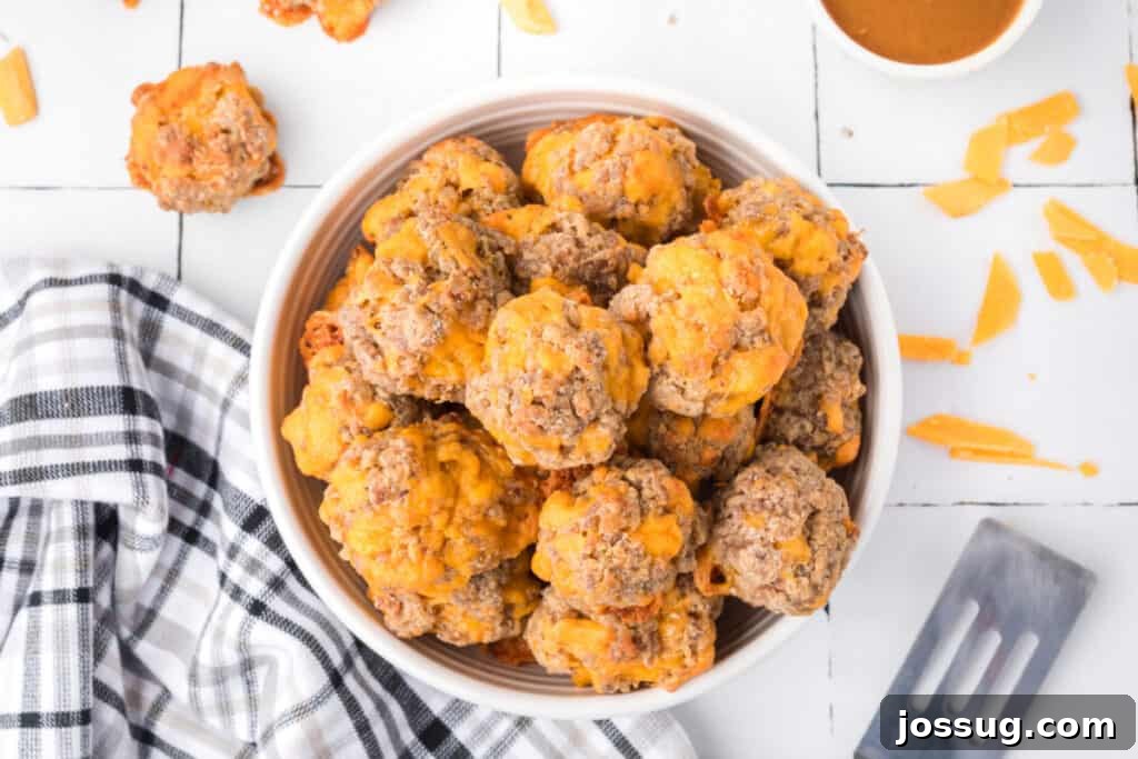Cheesy Sausage Balls 11 A bowl filled to the brim with freshly baked sausage balls, ready for serving at a gathering.
