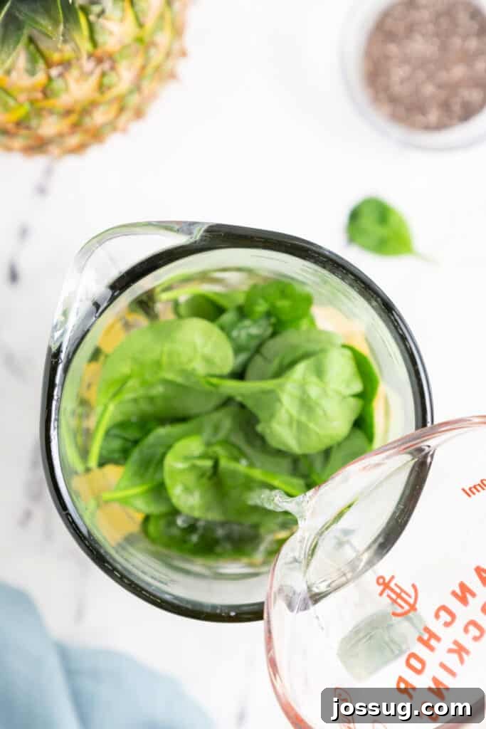 Add the spinach and coconut water.