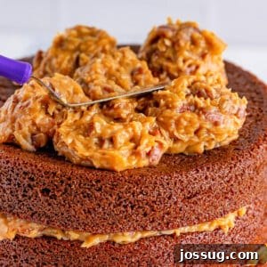Close up of coconut pecan frosting on top of a cake, showing its rich texture and deliciousness.