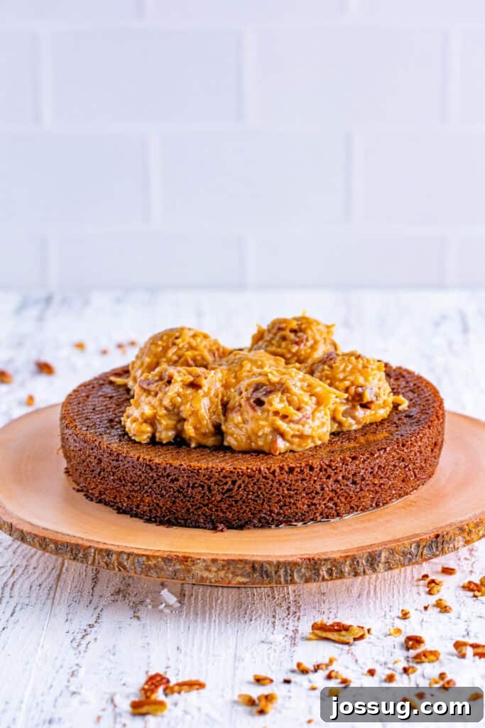 Chocolate Coconut Pecan Delight 14 Once cool, even the tops of the cakes if needed. Place one cake onto your serving platter. Add 1/3 of the frosting and smooth it out on top.