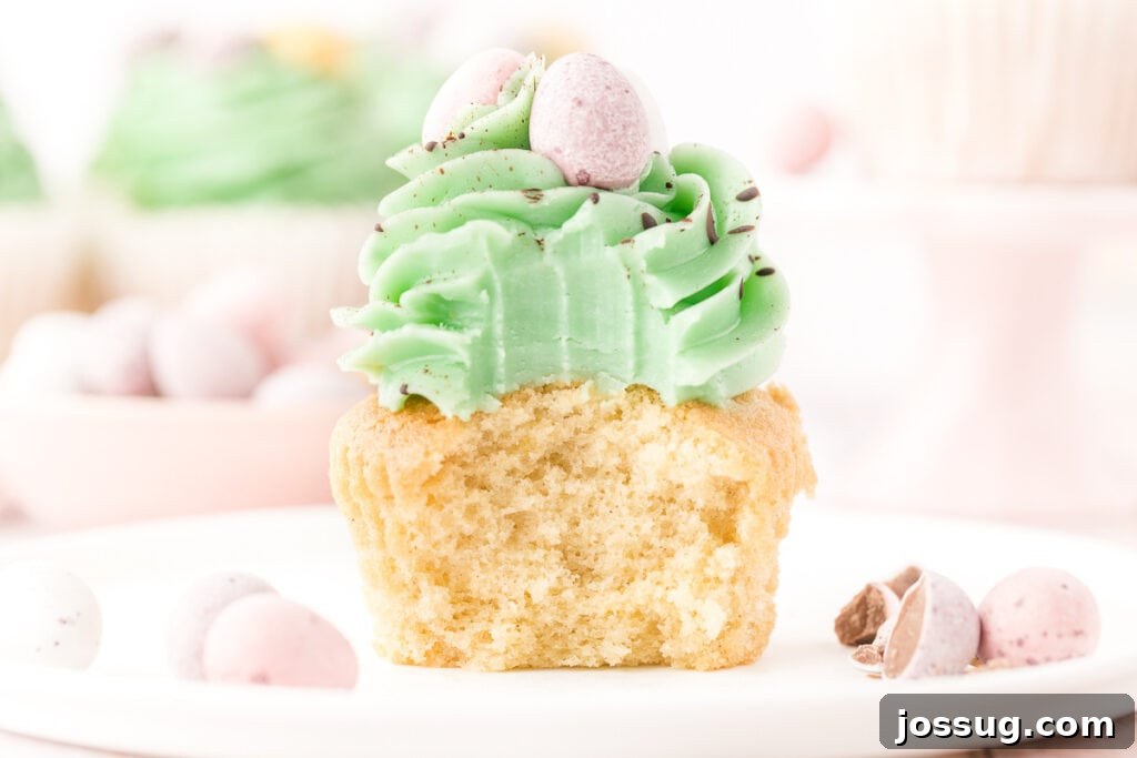 Hoppy Easter Vanilla Cupcakes 6 vanilla easter cupcake with bite taken out to show the crumb and texture, highlighting its moistness