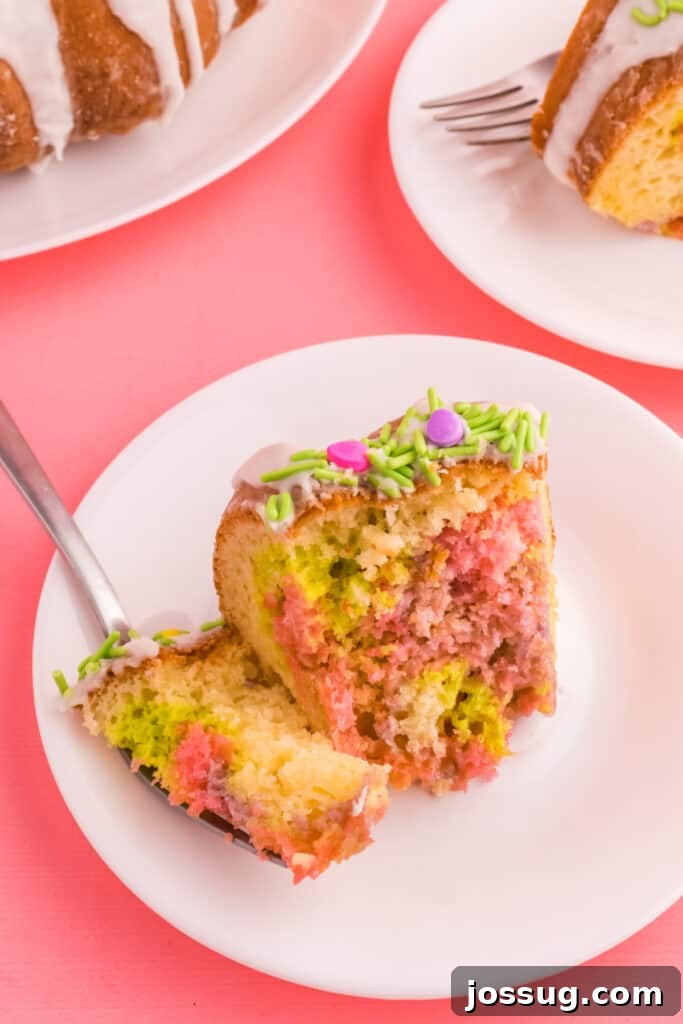 Close-up of a slice of Easter Swirl Bundt Cake on a plate with a bite taken from it on a fork