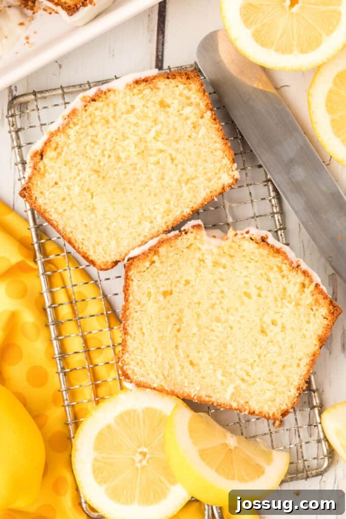 Signature Lemon Loaf 4 two slices of lemon loaf cooling on a wire rack, freshly glazed