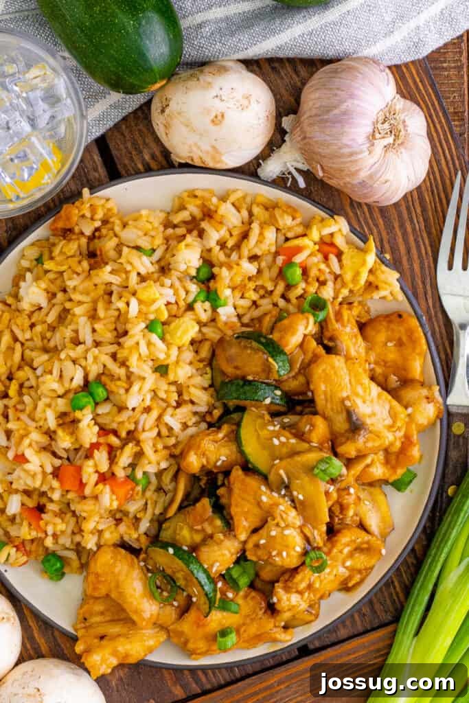 Homemade Panda Express Mushroom Chicken 5 Looking down onto a plate with fried rice and copycat Panda Express Mushroom Chicken, ready to be enjoyed