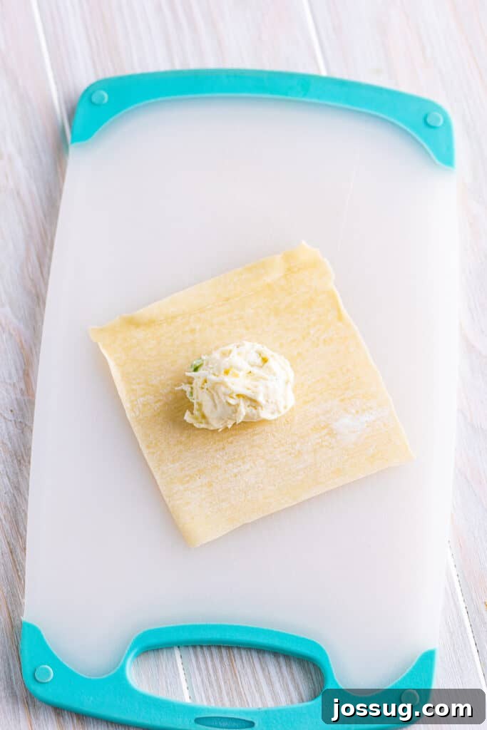 Crispy Crab Clouds 9 On a clean work surface, place a wonton wrapper. Add 1 tablespoon of the filling in the center.