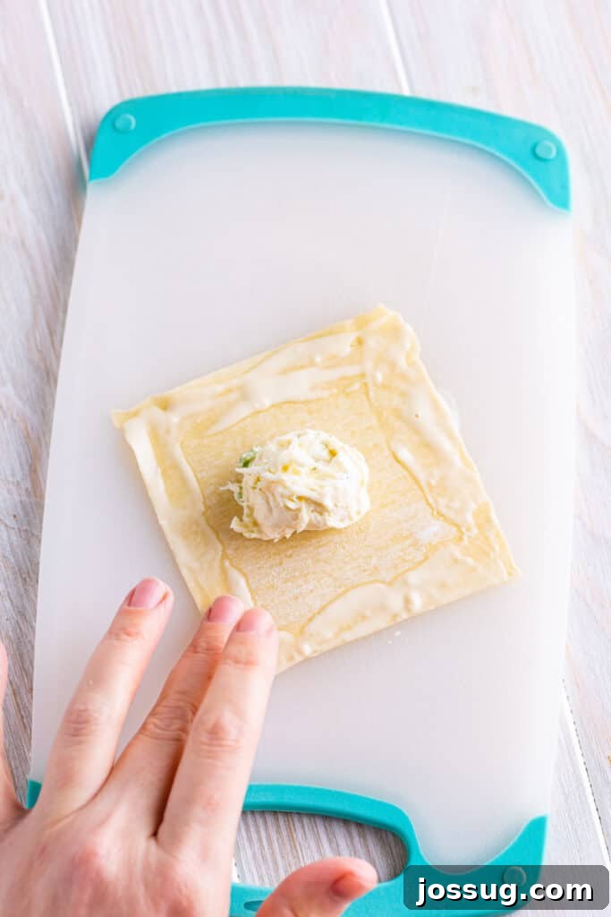 Crispy Crab Clouds 10 Dip a fingertip into the flour mixture and run it along the outside edge of the wrapper.