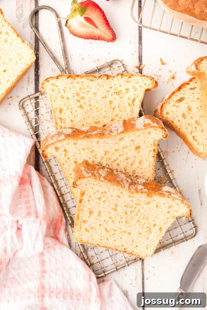 Three perfectly toasted slices of English Muffin Bread cooling on a wire rack, ready to be served.