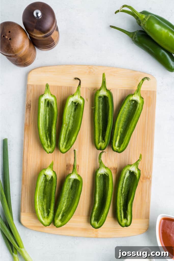 Cut the jalapenos in half lengthways, remove the seeds and membranes, and then set aside.