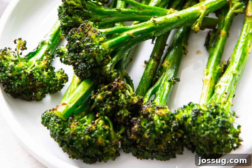 Crispy Air-Fried Broccolini 11 closeup of air fryer broccolini on white pate