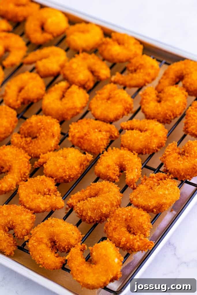 then transfer to a wire rack. Repeat the process with remaining shrimp.