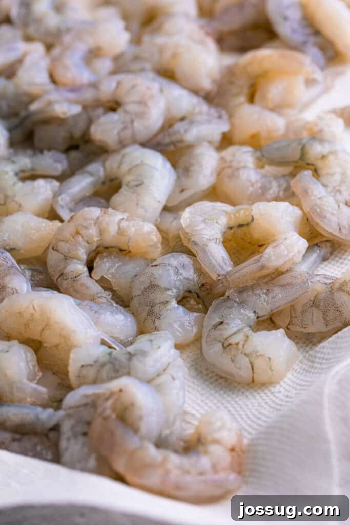 Heat peanut oil in a deep fryer or Dutch oven to 350°F. Dry the shrimp with paper towels.