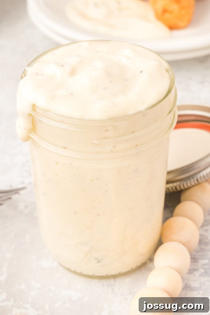 Creamy Dill & Caper Dressing 2 Close-up of freshly made tartar sauce in a mason jar with the lid off, ready to be served.