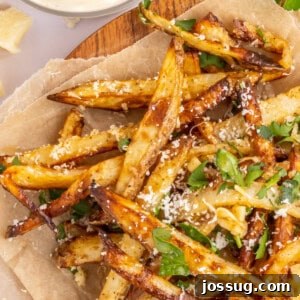 Closeup of perfectly cooked crispy Air Fryer Garlic Parmesan Fries, showing their golden texture and savory seasoning.