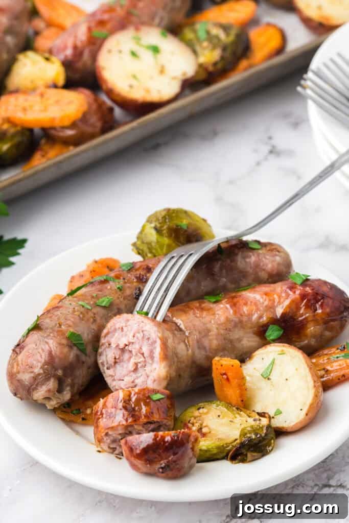 Roasted Sausage and Veggie Medley 5 serving of baked sausage and veggies on plate with garnishes