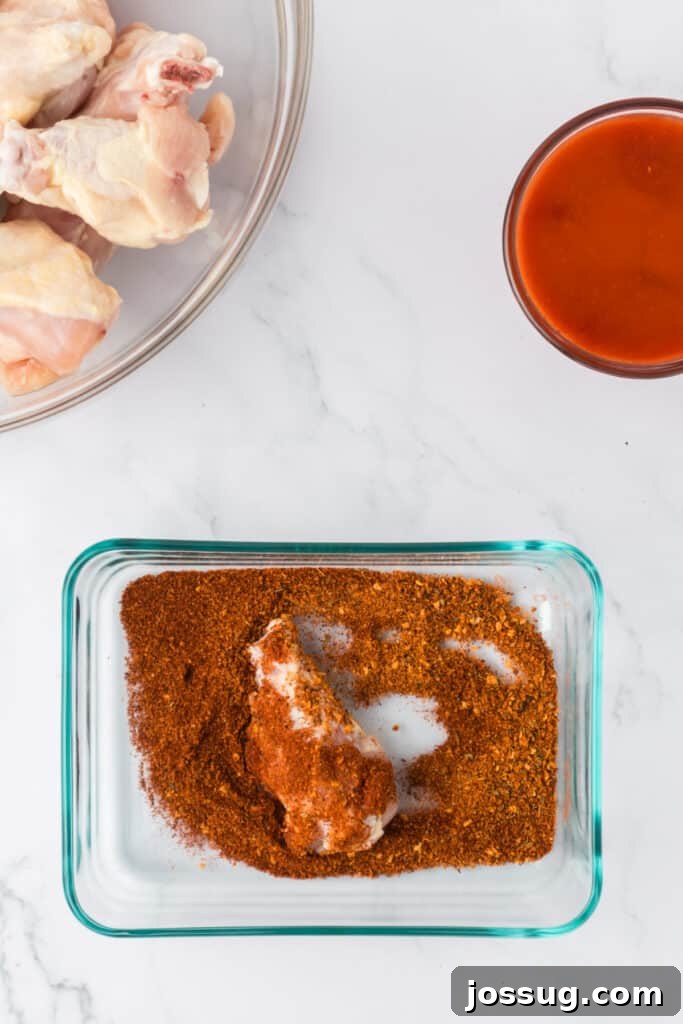 Perfectly Crispy Air Fryer Buffalo Wings 4 Coating raw chicken wings in seasoning mix