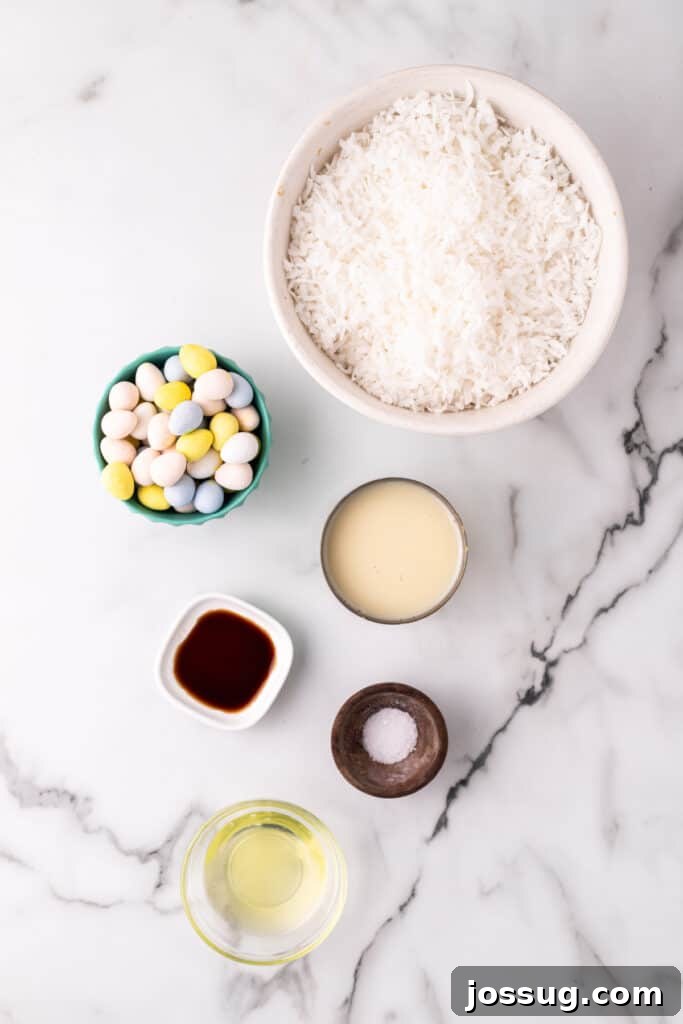 Essential ingredients for making chewy coconut Easter nests, including flake coconut, sweetened condensed milk, egg white, vanilla extract, salt, and colorful mini egg candies, laid out on a wooden surface.