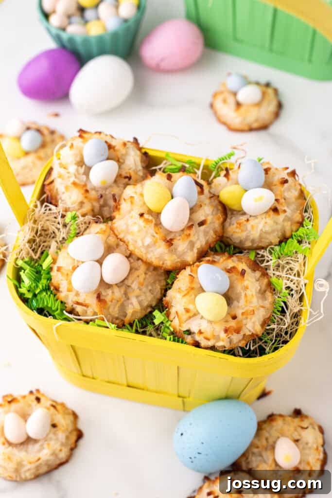 A close-up shot of several golden-brown coconut Easter nests, filled with an assortment of pastel-colored mini egg candies, arranged beautifully in a yellow decorative basket, ready for serving.
