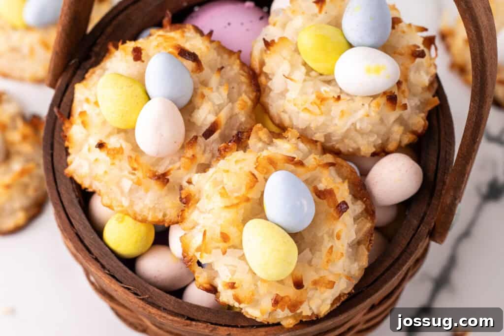 An inviting close-up of a perfectly baked coconut Easter nest, showcasing its golden-brown, chewy texture and the vibrant collection of multi-colored Cadbury mini eggs nestled within, presented in a basket.