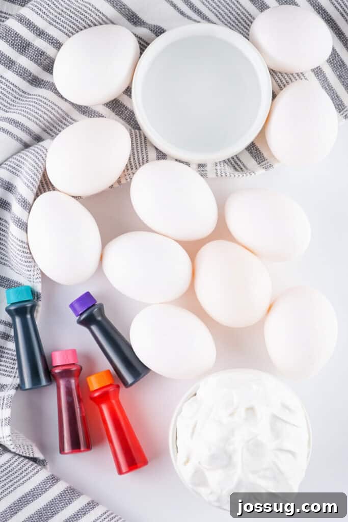Cool Whip Marbled Easter Eggs 3 Ingredients laid out for making cool whip dyed Easter eggs, including Cool Whip, food dye, vinegar, and hard-boiled eggs