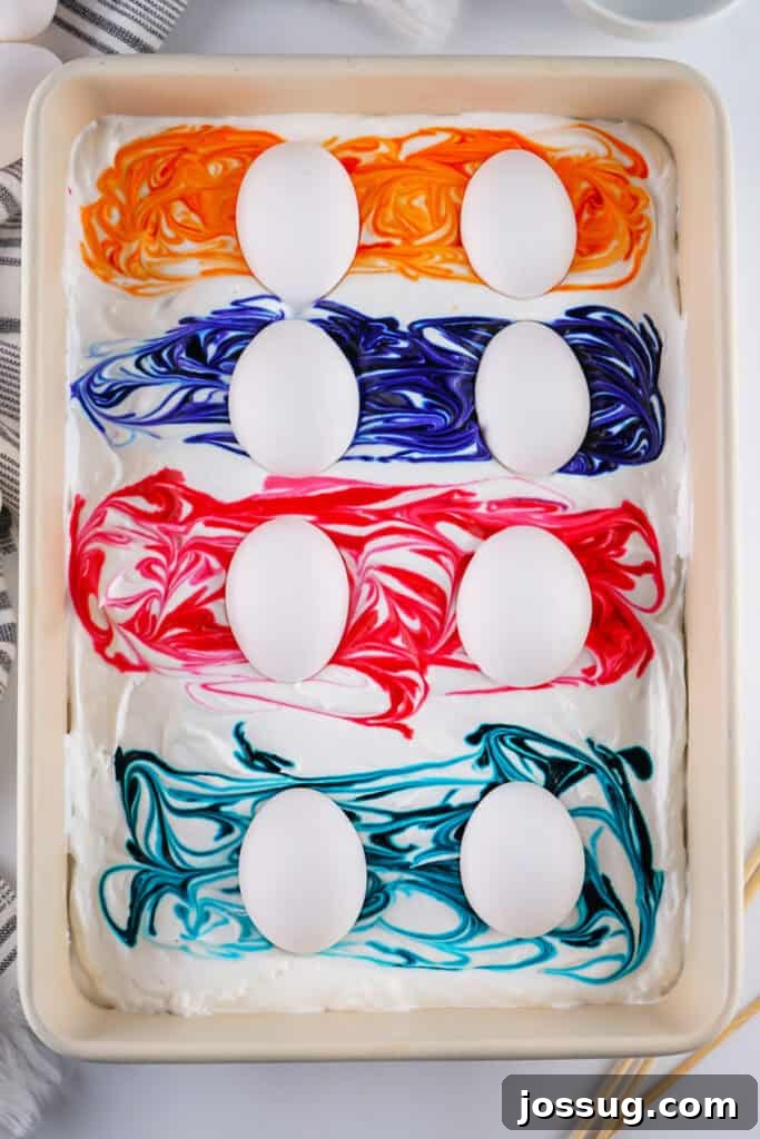 Cool Whip Marbled Easter Eggs 6 Hard-boiled eggs carefully placed onto the swirled Cool Whip and food dye mixture