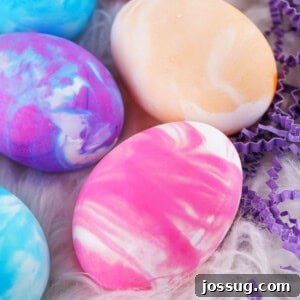 Closeup of vibrant cool whip dyed Easter eggs, showcasing their marbled patterns