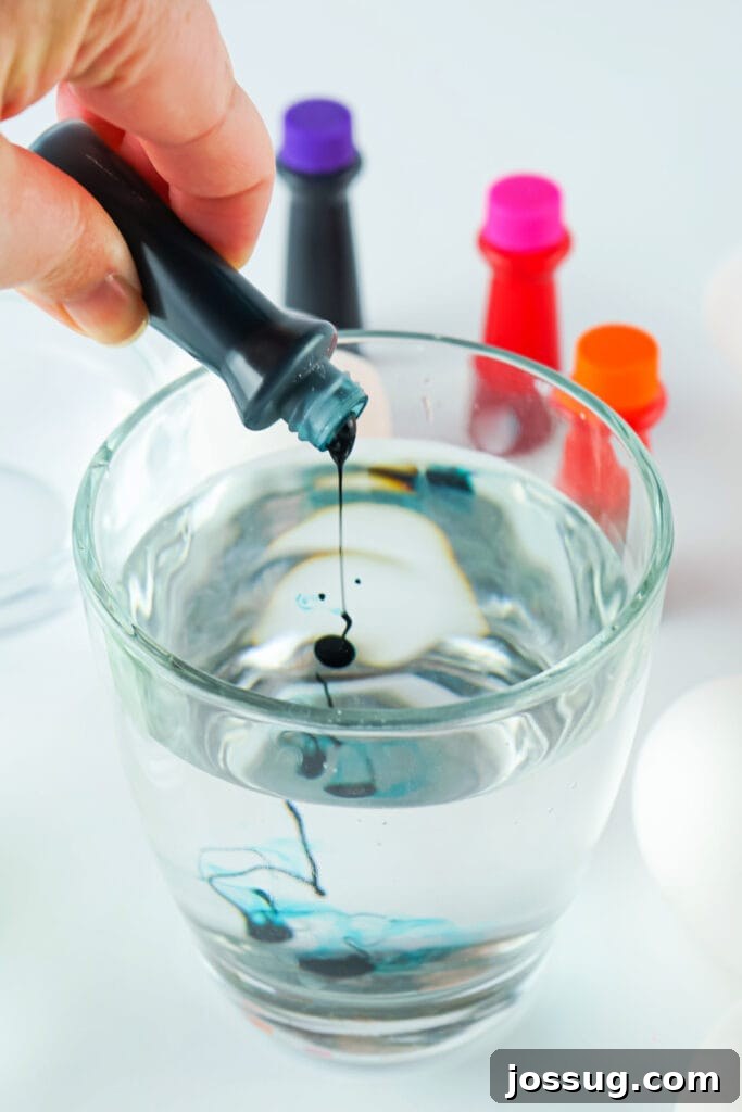 Mixing food dye into the water and vinegar solution for egg dyeing