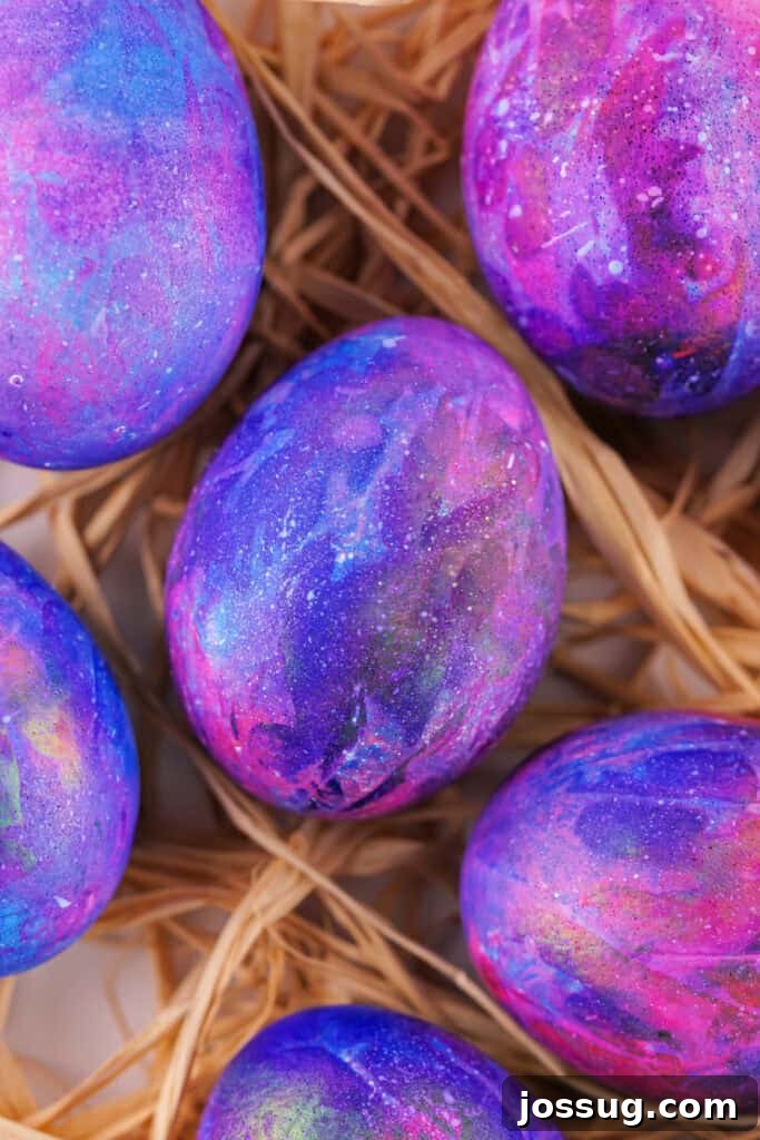 Cosmic Curiosities Uncovered 2 Several vibrant galaxy easter eggs showcasing cosmic colors and starry splatters.