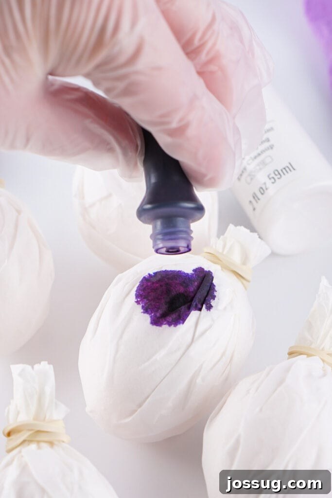 Cosmic Curiosities Uncovered 5 Liquid food dye being applied in drops onto a coffee filter wrapped egg.
