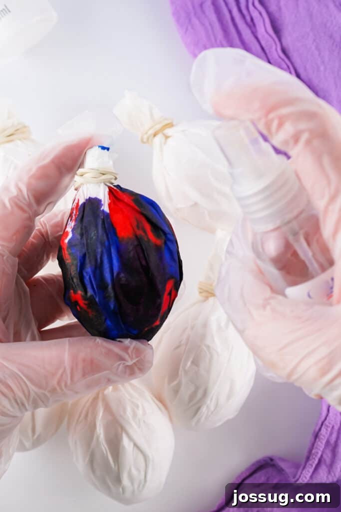 Cosmic Curiosities Uncovered 6 Vinegar being spritzed onto the dye-soaked coffee filter wrapped egg to set the color.