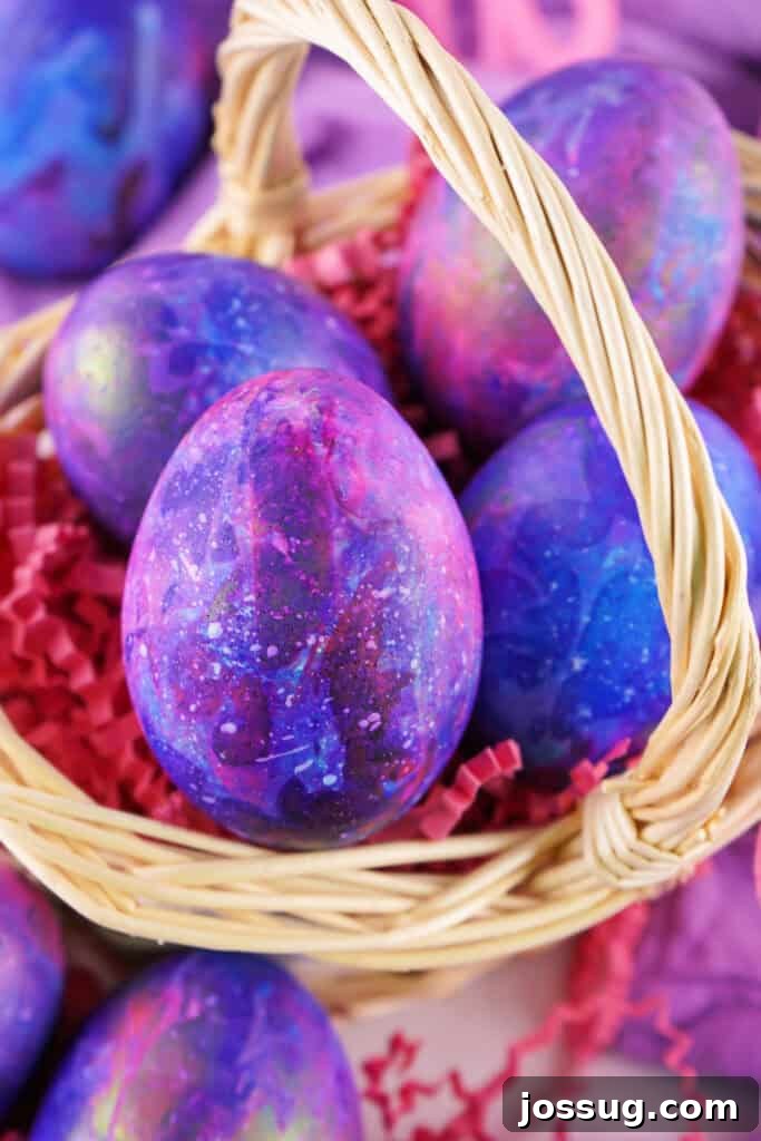 Cosmic Curiosities Uncovered 8 A basket filled with finished galaxy easter eggs, ready for display.