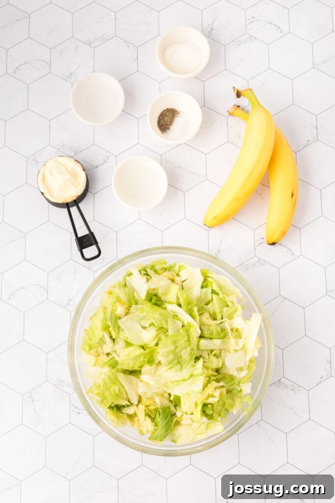 Grandma's Banana Lettuce Salad 3 Ingredients laid out for making the banana lettuce salad, including fresh lettuce, ripe bananas, and dressing components.