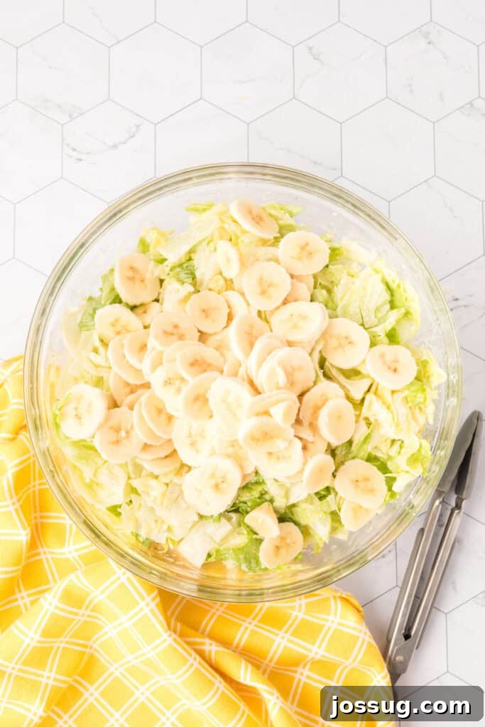 Grandma's Banana Lettuce Salad 6 Thinly sliced bananas arranged on top of the dressed lettuce, before final mixing.