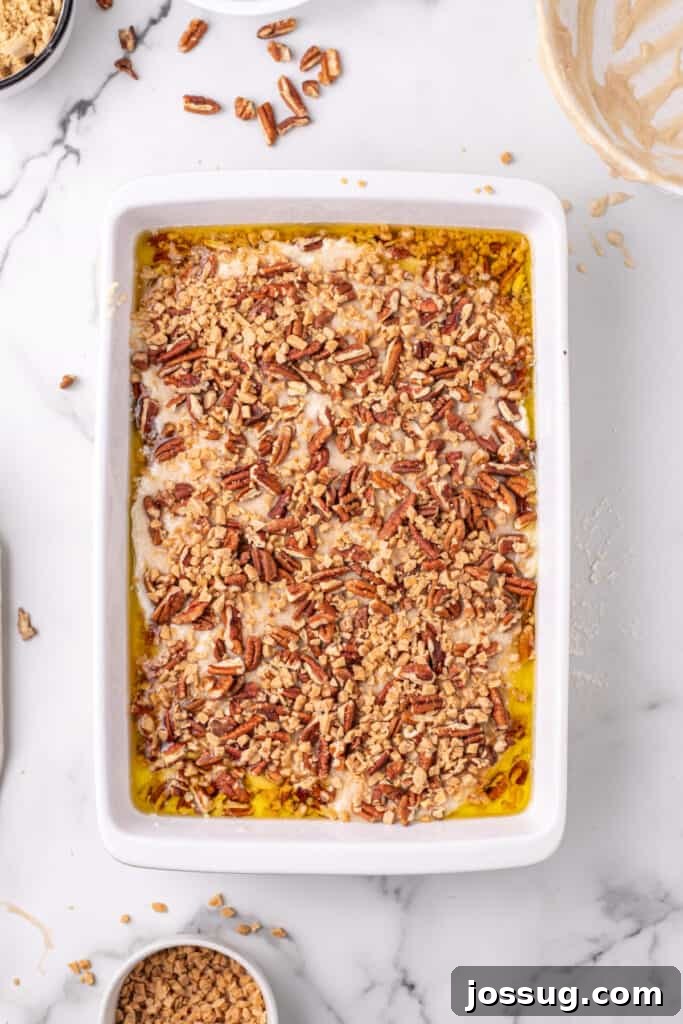 Decadent Pecan Cobbler 5 Pecan Pie Cobbler before being baked topped with pecan and toffee bits