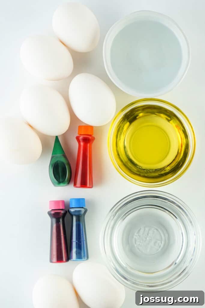Essential supplies laid out for making marbled Easter eggs: hard-boiled eggs, food dye, oil, vinegar, and bowls
