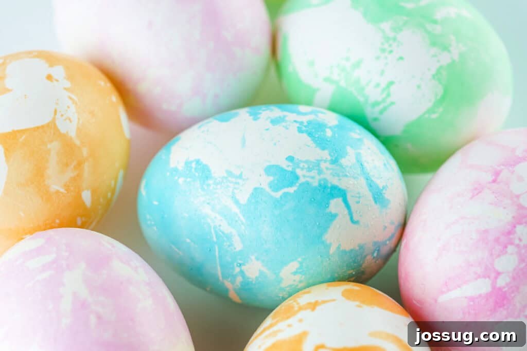 Several assorted colors of vibrant marbled Easter eggs arranged together