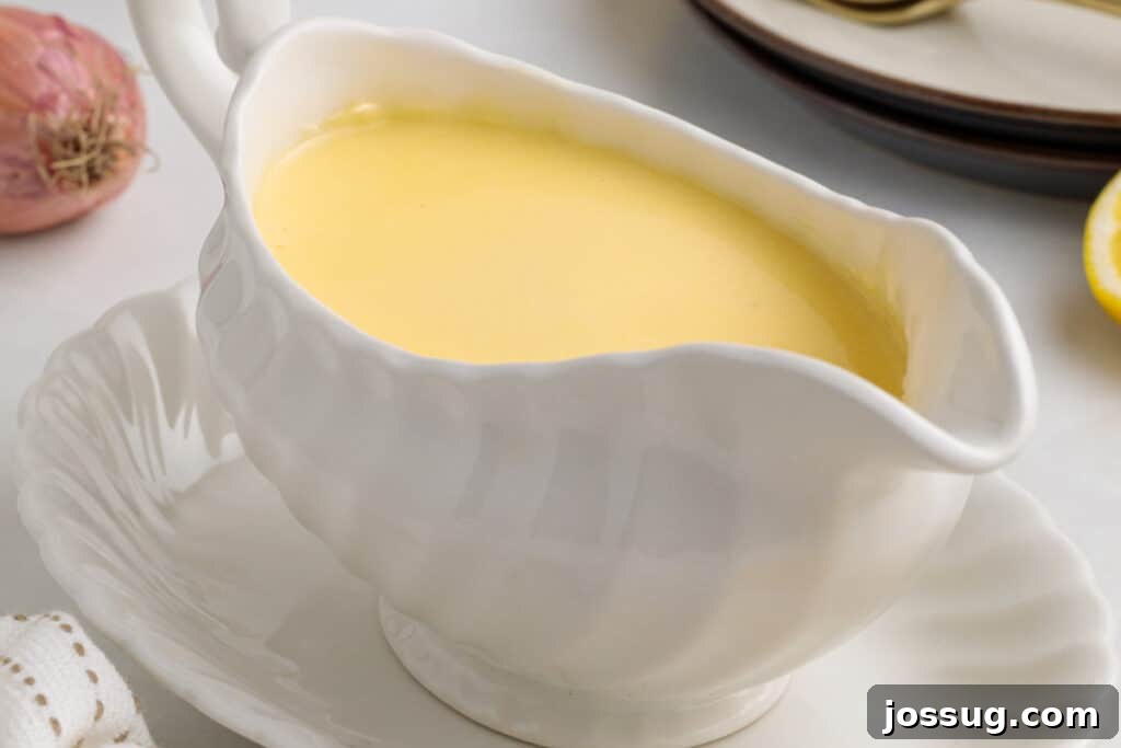 Zesty Lemon Butter Drizzle 9 Silky lemon butter sauce (beurre blanc) elegantly presented in a classic white gravy boat, ready to be served.