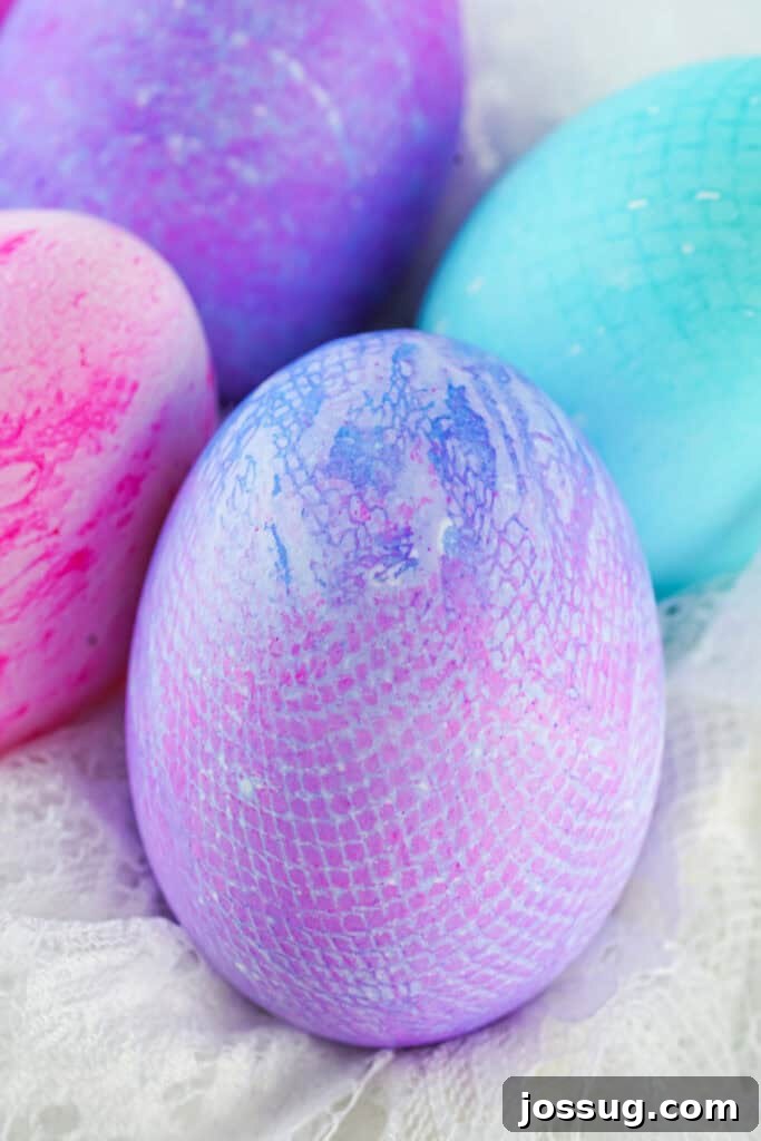 Textile Art Easter Eggs 8 Several assorted colors of fabric textured Easter eggs displayed in a wooden bowl, showing varied patterns.