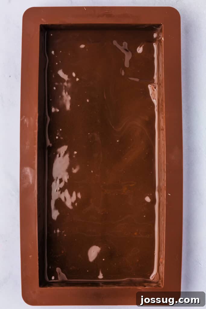 Golden Dubai Delight 11 Mold filled with smooth melted chocolate coating the base and sides evenly.