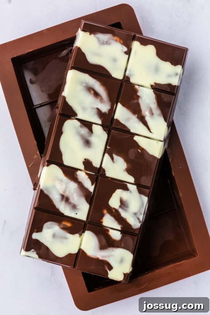 Golden Dubai Delight 14 Unmolded Dubai Chocolate Bar showing a glossy chocolate shell with white decorative swirls.