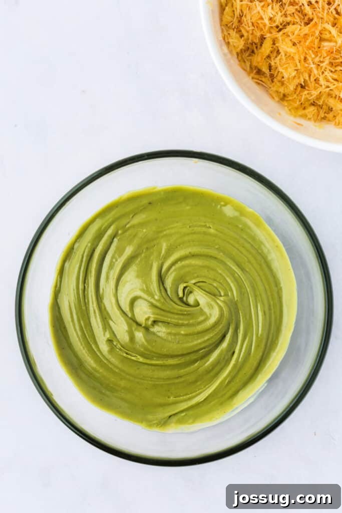 Golden Dubai Delight 7 Smoothly mixed pistachio butter and tahini in a glass bowl, forming a creamy green base.