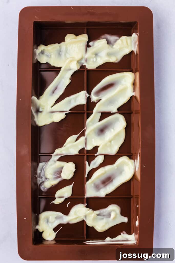 Golden Dubai Delight 10 Silicone chocolate bar mold with white melting candy drizzled in a decorative pattern.