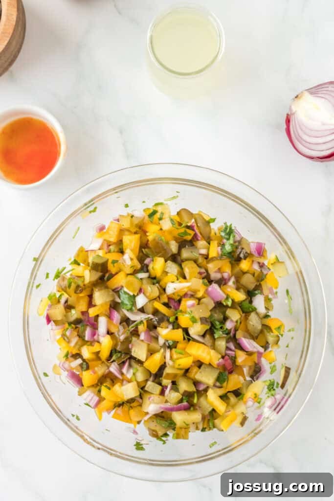 Pickle de Gallo ingredients fully mixed in a clear bowl, showing a colorful combination of diced vegetables and herbs.