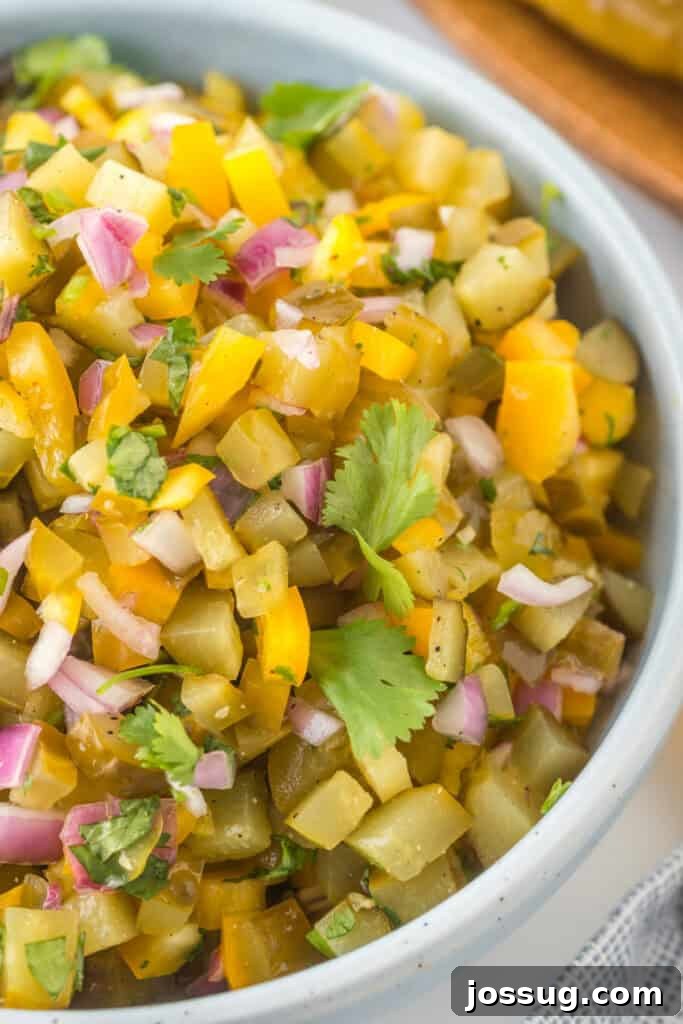 Close-up of Pickle de Gallo in a bowl, highlighting the chopped pickles, peppers, onion, and cilantro.