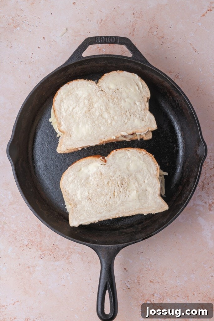 Sweet and Savory Blackberry Grilled Cheese 12 Two buttered sandwiches carefully placed in a cast iron skillet, poised for grilling to golden perfection