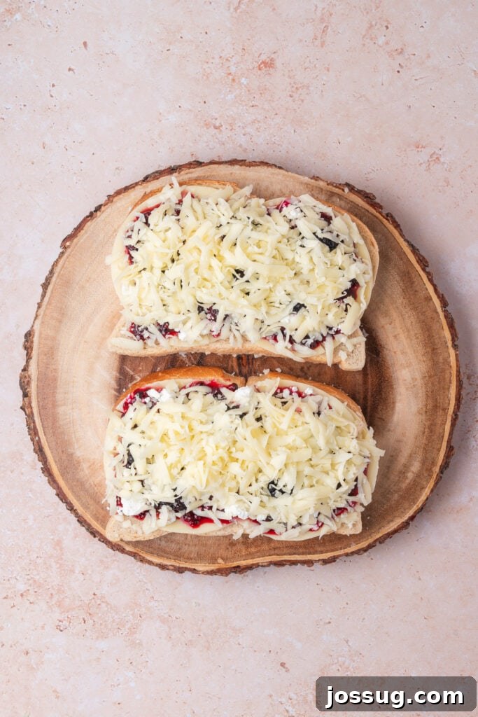 Sweet and Savory Blackberry Grilled Cheese 10 The final cheese layer of shredded mozzarella added on top of the jam and goat cheese, completing the sandwich filling