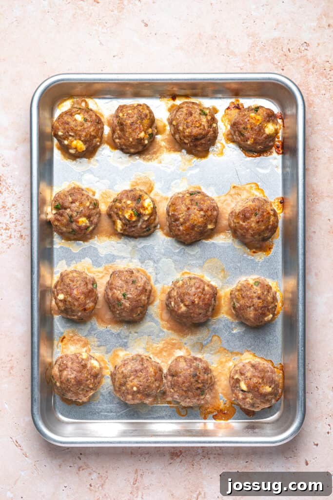 Cooked turkey feta meatballs fresh from the oven with browned tops and melted cheese