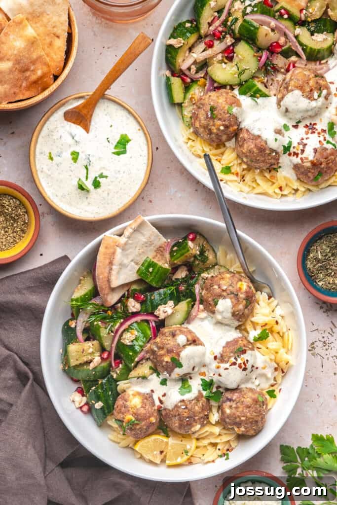 Overhead shot of two bowls filled with turkey feta meatballs, orzo, tzatziki, and cucumber salad