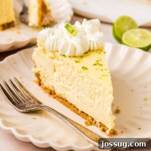 Closeup of a slice of Key Lime Cheesecake on a plate, garnished with a lime wedge