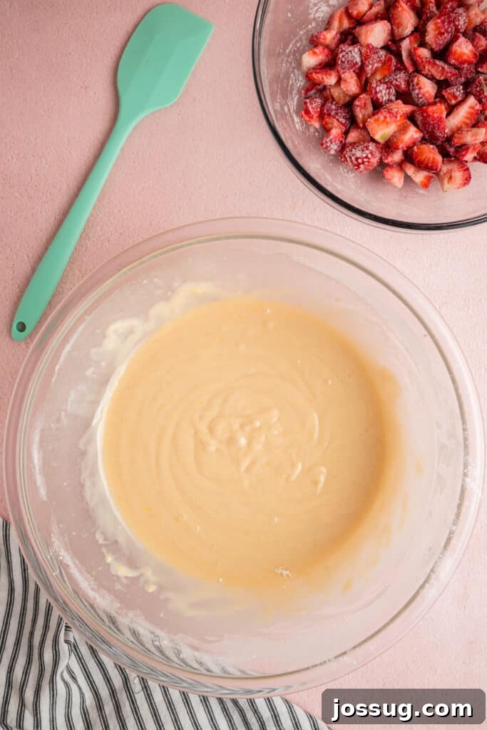Sweet Strawberry Loaf 11 A thick, glossy strawberry bread batter in a glass bowl, perfectly mixed and ready for the floured strawberries to be folded in.