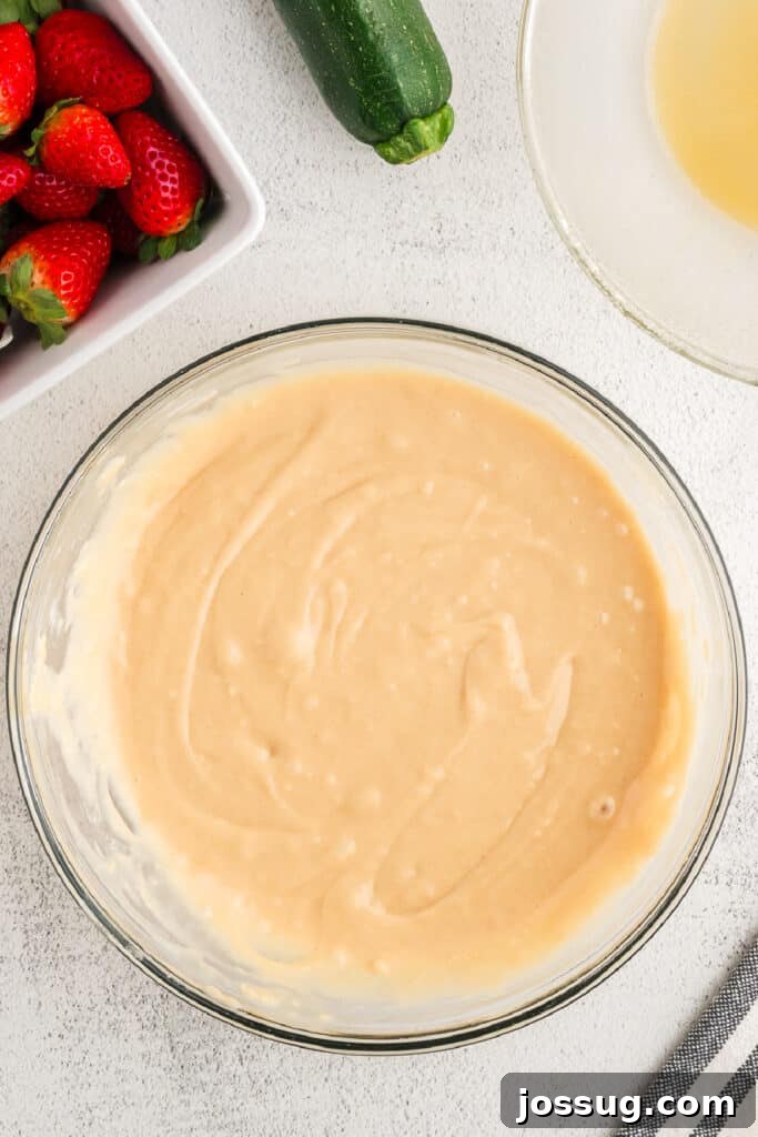 The strawberry zucchini bread batter is perfectly mixed in the bowl, smooth and ready for the final delicious add-ins.